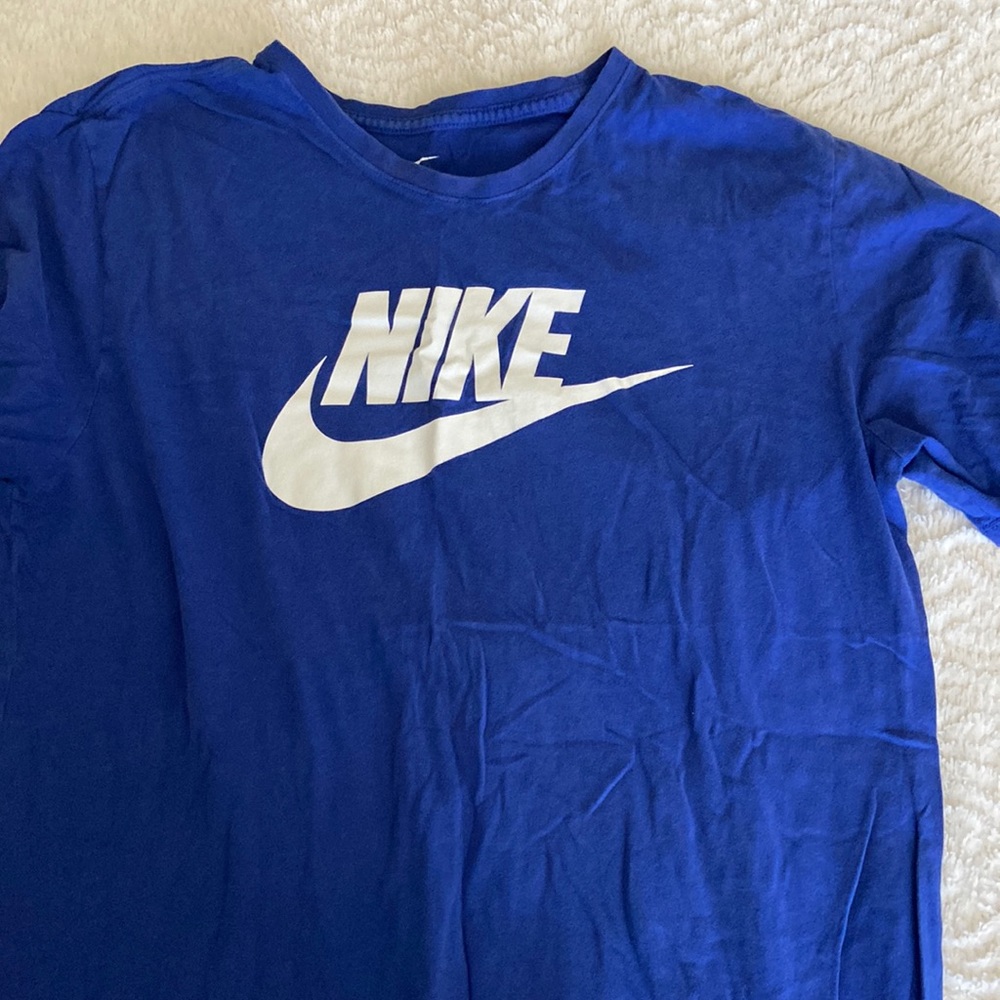 Large blue Nike swoosh T